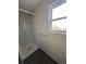 Clean shower with marble-style tile and a window at 2084 S Rifle St, Aurora, CO 80013