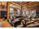 Open living space featuring exposed brick, wood beams, and a large leather sectional sofa at 1792 Wynkoop St # 505, Denver, CO 80202