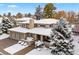 Two-story home with three-car garage and snow-covered landscaping at 4800 E Cedar Ave, Denver, CO 80246