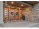 Elegant entryway with double doors and stonework at 12963 Silver Elk Ln, Littleton, CO 80127