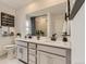 Elegant bathroom with dual sinks, modern vanity, and a large mirror at 16691 W 93Rd Ave, Arvada, CO 80007