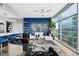 Modern living room with blue accent wall and city views at 1700 Bassett St # 1901, Denver, CO 80202
