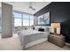 Main bedroom with dark accent wall and city views at 1700 Bassett St # 1901, Denver, CO 80202