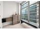 Bedroom with modern dresser and city views at 1700 Bassett St # 1901, Denver, CO 80202