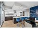 Modern kitchen with marble island, blue barstools, and city views at 1700 Bassett St # 1901, Denver, CO 80202