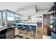 Modern kitchen with marble island, blue barstools, and city views at 1700 Bassett St # 1901, Denver, CO 80202