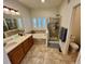 Primary bathroom with double sinks, tub, and shower at 8802 E 24Th Pl # 101, Denver, CO 80238