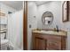 Bathroom with wood vanity and shower/tub combo at 2362 S Troy St, Aurora, CO 80014