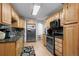 Galley kitchen with stainless steel appliances and granite countertops at 2362 S Troy St, Aurora, CO 80014