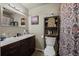 Main bathroom with double vanity and patterned shower curtain at 2362 S Troy St, Aurora, CO 80014