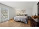 Main bedroom with wood floors and sliding glass door to patio at 2362 S Troy St, Aurora, CO 80014