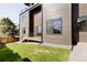 Modern home exterior with gray siding and grassy yard at 16113 W 14Th Ave, Golden, CO 80401