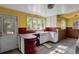 Kitchen features retro style, yellow walls and white cabinets at 577 96Th St, Louisville, CO 80027