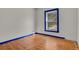 Simple bedroom with hardwood floors and a window at 577 96Th St, Louisville, CO 80027