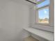 Small closet with built-in shelves and window offering natural light at 577 96Th St, Louisville, CO 80027