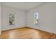 Bright bedroom with hardwood floors and two windows at 577 96Th St, Louisville, CO 80027