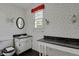 Second bathroom with sink, toilet, and vintage wallpaper at 577 96Th St, Louisville, CO 80027