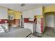 Retro kitchen with yellow and brown tile and white cabinets at 577 96Th St, Louisville, CO 80027