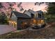 Two-story house exterior with a three-car garage and landscaping at 6024 Meadow Dr, Morrison, CO 80465