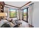 Cozy reading room with leather armchairs, built-in shelves, and scenic views at 7944 Dante Dr, Littleton, CO 80125