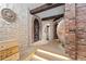 Wine cellar hallway with stone walls and large clay pot at 7944 Dante Dr, Littleton, CO 80125