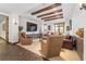 Spacious basement recreation room with wood beams and large TV at 7944 Dante Dr, Littleton, CO 80125