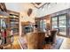 Spacious library with a fireplace, built-in bookshelves, and hardwood floors at 7944 Dante Dr, Littleton, CO 80125
