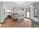 Bright bedroom with a four-poster bed and access to a balcony at 7944 Dante Dr, Littleton, CO 80125