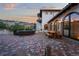 Brick patio with seating area and fire pit, offering scenic views at 7944 Dante Dr, Littleton, CO 80125
