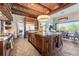 Open kitchen boasts a large island, custom cabinetry, and views at 7944 Dante Dr, Littleton, CO 80125