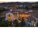 Night view of a grand home with a large patio, nestled in a mountain community at 7944 Dante Dr, Littleton, CO 80125