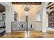 Grand hallway with stone walls, hardwood floors and chandelier at 7944 Dante Dr, Littleton, CO 80125