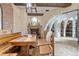 Rustic tasting room with farmhouse table and stone fireplace at 7944 Dante Dr, Littleton, CO 80125