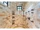 Large walk-in shower with multiple shower heads and tile surround at 7944 Dante Dr, Littleton, CO 80125