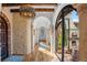 Hallway with hardwood floors and stone walls, leading to courtyard at 7944 Dante Dr, Littleton, CO 80125