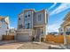 Two-story home with gray siding, attached garage, and a modern design at 16172 E 111Th Dr, Commerce City, CO 80022