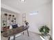 Modern home office with a large desk, built-in shelving, and natural light at 16172 E 111Th Dr, Commerce City, CO 80022