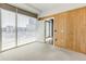 Bright bedroom with city view, large window, and wood-paneled wall at 2001 Lincoln St # 1024, Denver, CO 80202