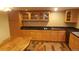 Fully equipped basement kitchen with wood cabinets and granite countertops at 6803 S Liverpool St, Centennial, CO 80016