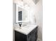 Contemporary bathroom with dark vanity, updated fixtures and a large mirror at 6930 E Girard Ave # 305, Denver, CO 80224