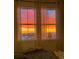 Bedroom with large windows offering stunning sunset views at 10334 Milwaukee Cir, Denver, CO 80229