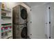 Laundry room with stacked washer and dryer, and shelving for storage at 10334 Milwaukee Cir, Denver, CO 80229