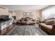 Living room with hardwood floors, two sofas, and a large area rug at 4981 Xanadu St, Denver, CO 80239