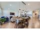 Bright dining area with farmhouse table and chairs, adjacent to the living room and kitchen at 4171 Happy Hollow Dr, Castle Rock, CO 80104