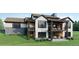 Luxury home with stone accents and patio at 6192 Oxford Peak Ln, Castle Rock, CO 80108