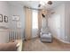 Bedroom with a crib, armchair, and plenty of natural light at 4546 Cholla Trl, Castle Rock, CO 80104