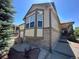 Beige two-story house with a large window and landscaped yard at 22840 E Heritage Pkwy, Aurora, CO 80016