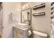 Clean bathroom with updated vanity and floating shelves at 30819 Hilltop Dr, Evergreen, CO 80439