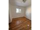 Simple bedroom with hardwood floors and a window at 6441 S Eudora Way, Centennial, CO 80121