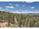 Aerial view of property with mountain views and a large yard at 15854 Cathedral Trl, Conifer, CO 80433